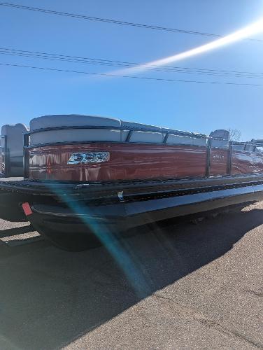 Slide: The Image of 2024 Regency 250 LE3 Sport pontoon boat under clear blue sky. - 0
