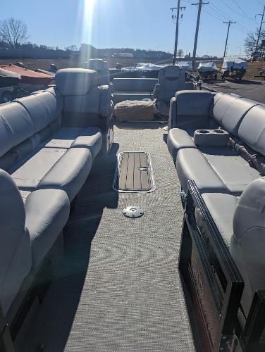 Slide: The Image of 2024 Regency 250 LE3 Sport pontoon boat interior with plush seating and spacious layout. - 3