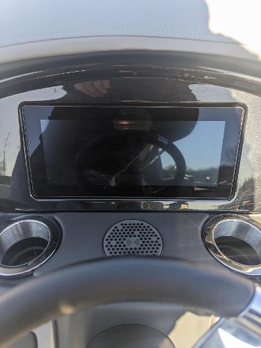 Slide: The Image of 2024 Regency 250 LE3 Sport dashboard with touchscreen and cup holders. - 4