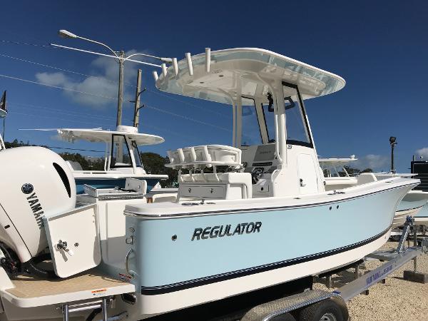 Slide: The Image of 2023 Regulator 23 boat with Yamaha engine, displayed on a trailer under clear blue sky. - 1