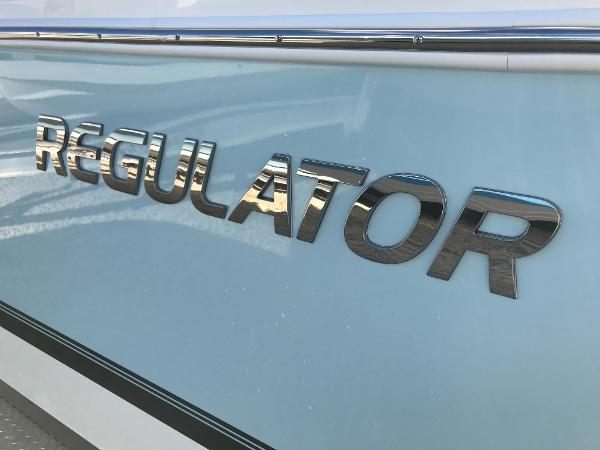 Slide: The Image of 2023 Regulator 23 boat logo on light blue hull. - 29