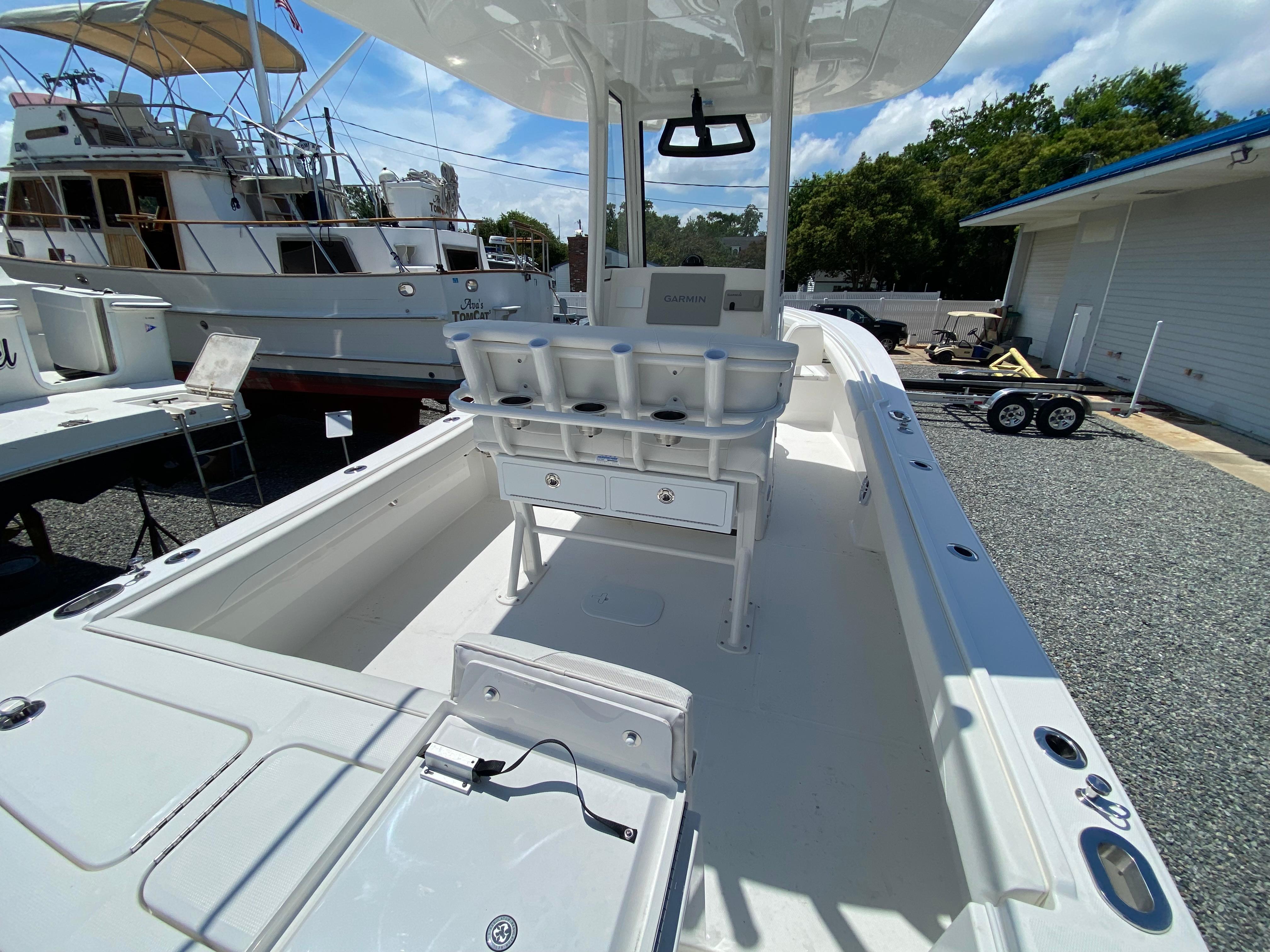 Slide: The Image of 2024 Regulator 23 boat interior with fishing rod holders and Garmin navigation system. - 28