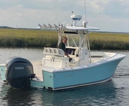 Slide: The Image of 2005 Regulator 23 Center Console boat with Yamaha engine on calm water. - 16