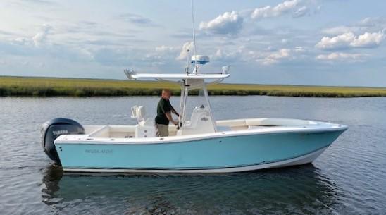Slide: The Image of 2005 Regulator 23 Center Console boat on calm water, side view. - 5