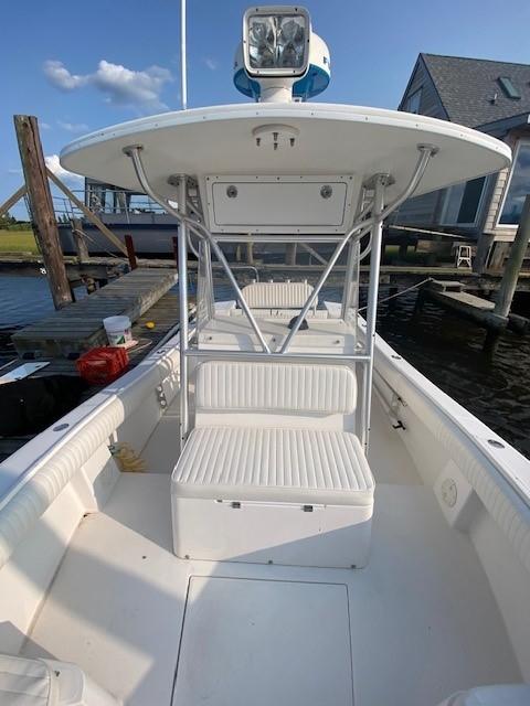 Slide: The Image of 2005 Regulator 23 Center Console boat docked, featuring spacious seating and a sturdy T-top. - 8