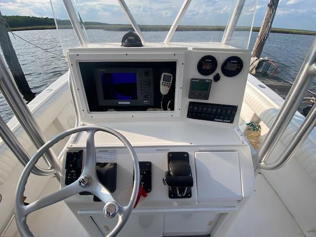 Slide: The Image of 2005 Regulator 23 Center Console boat dashboard with steering wheel and navigation equipment. - 9