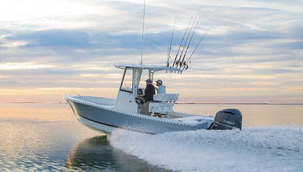 Slide: The Image of 2026 Regulator 24XO boat cruising on calm water at sunset. - 1