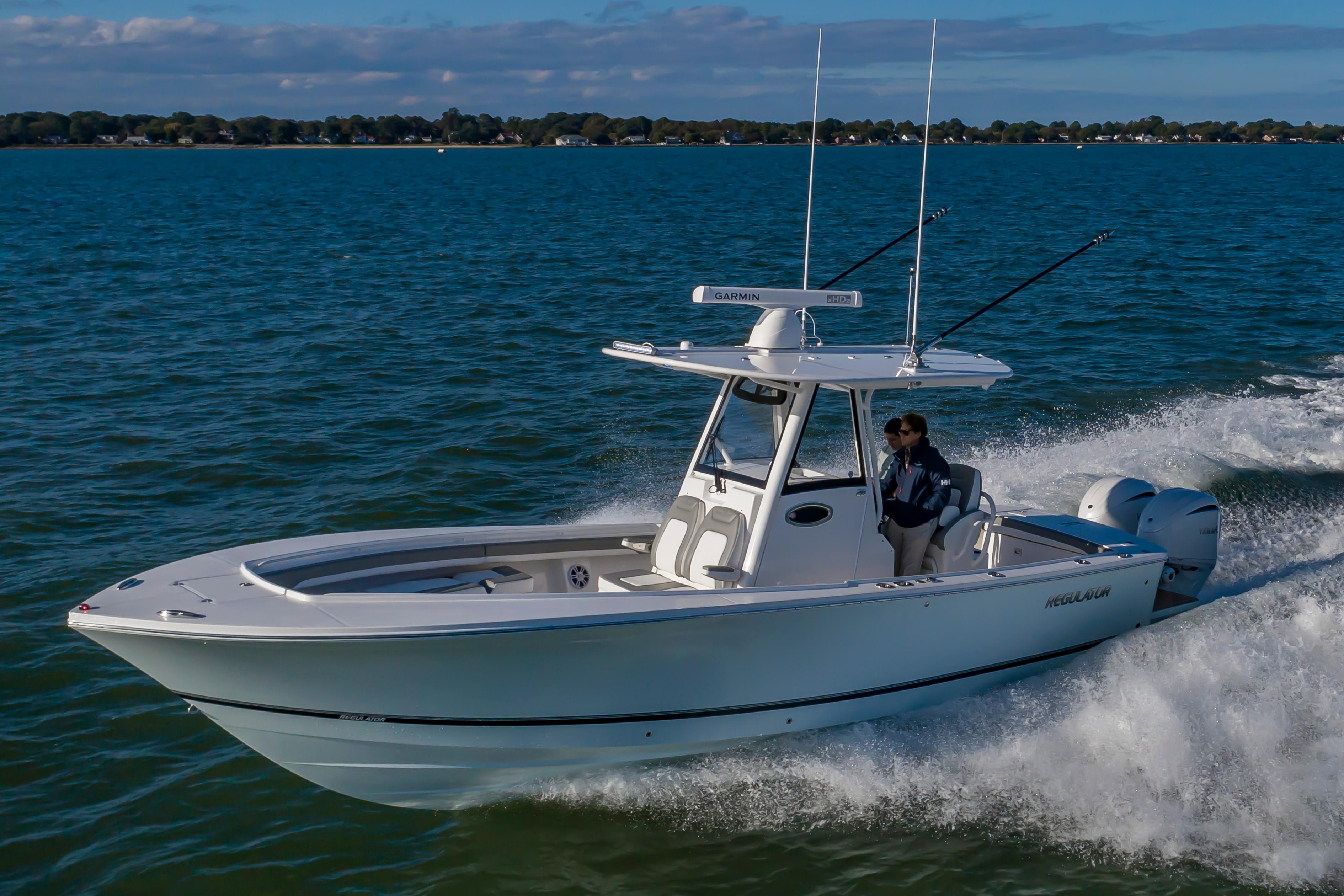 Slide: The Image of 2024 Regulator 28 boat cruising on open water. - 0
