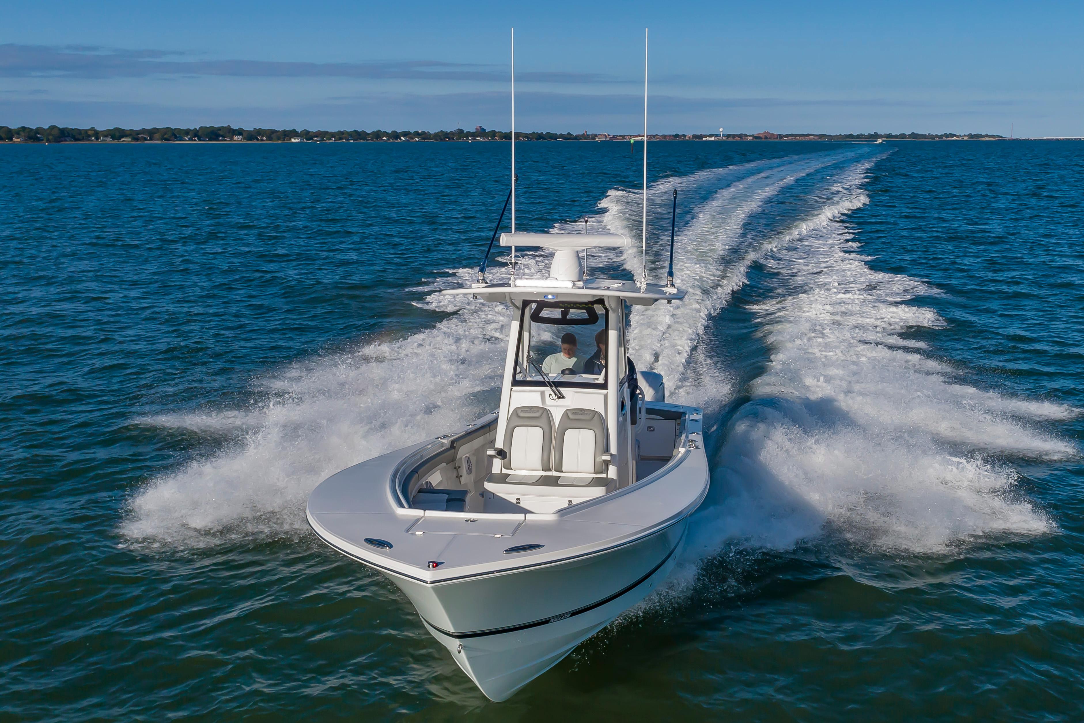 Slide: The Image of 2024 Regulator 28 boat cruising on open water. - 1