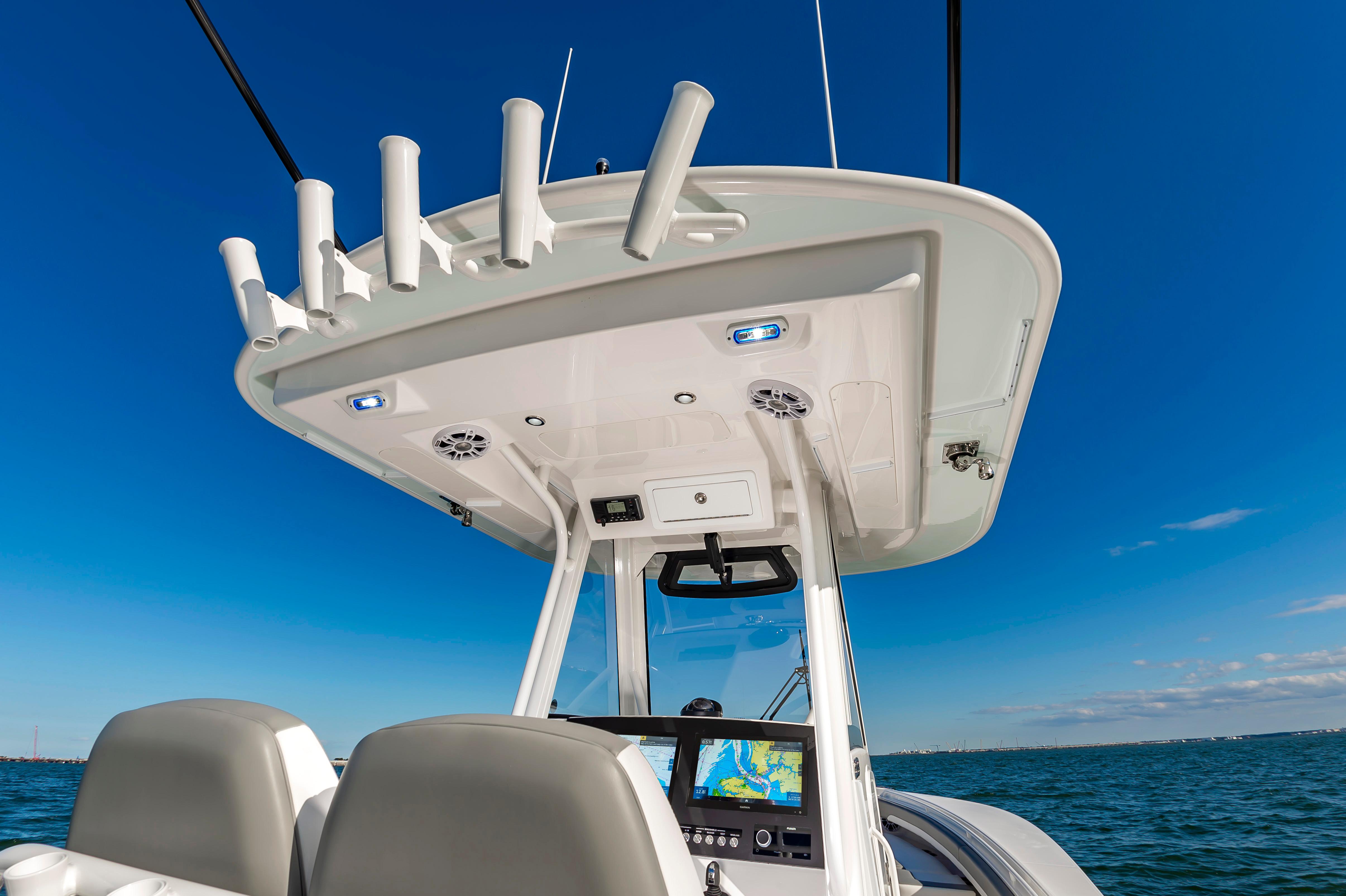 Slide: The Image of 2024 Regulator 28 boat console with navigation screens and rod holders. - 13