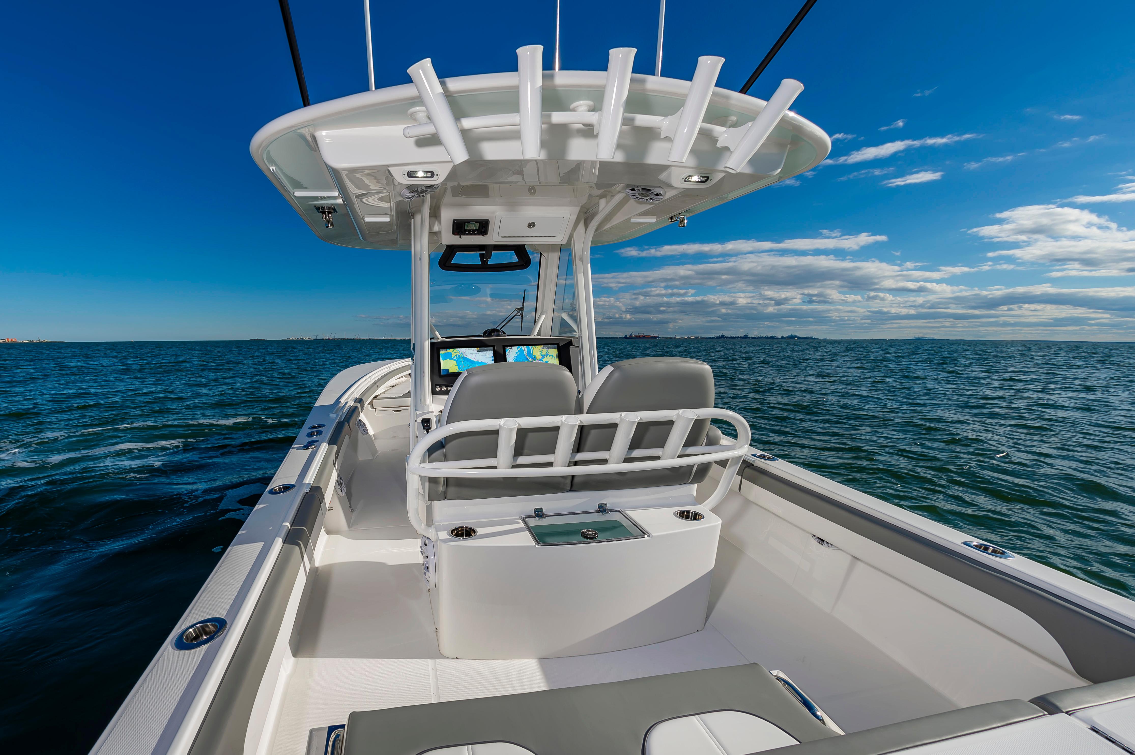 Slide: The Image of 2024 Regulator 28 boat on open water with dual helm seats and navigation screens. - 14