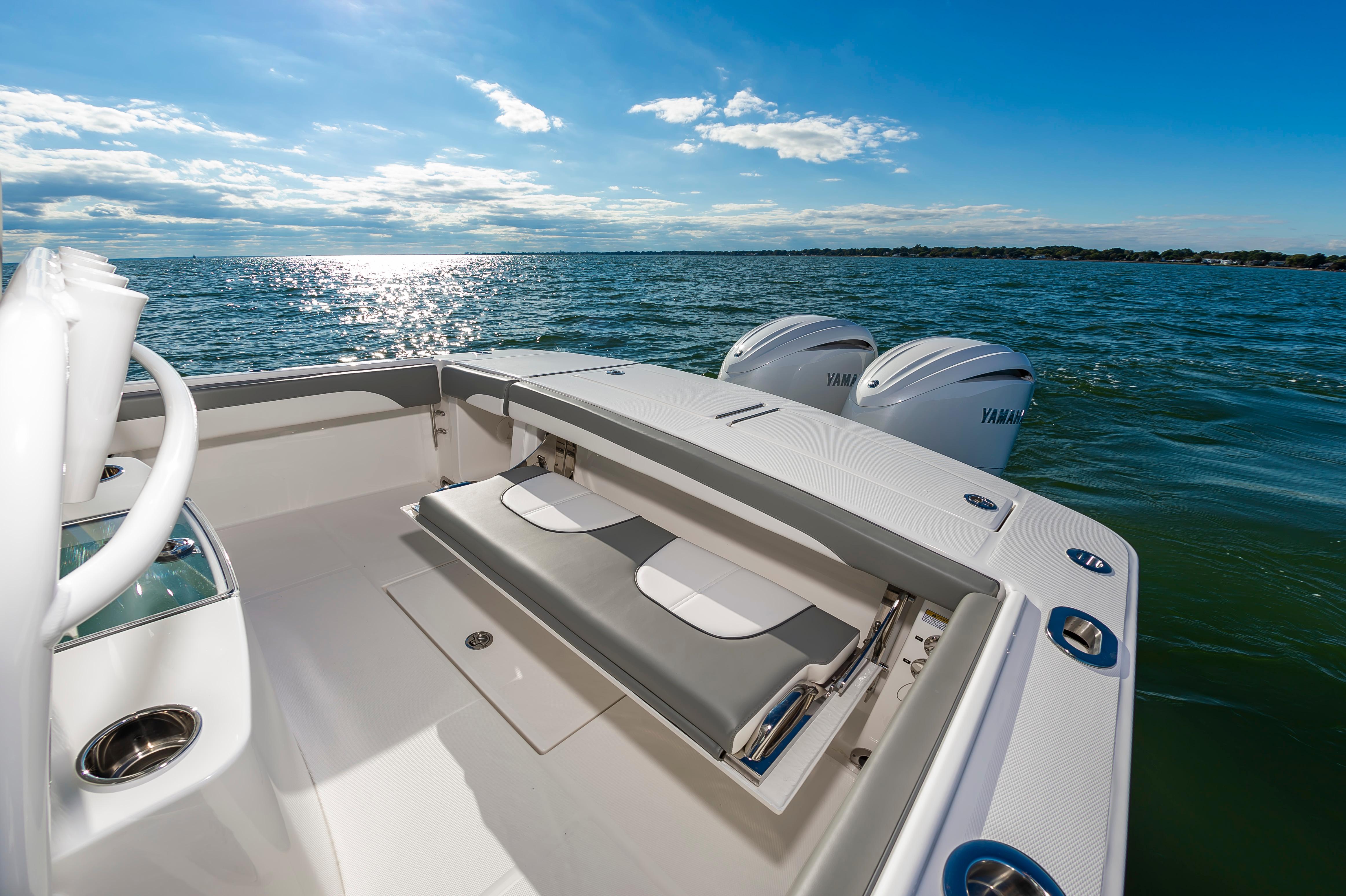 Slide: The Image of 2024 Regulator 28 boat with dual Yamaha engines on open water. - 16