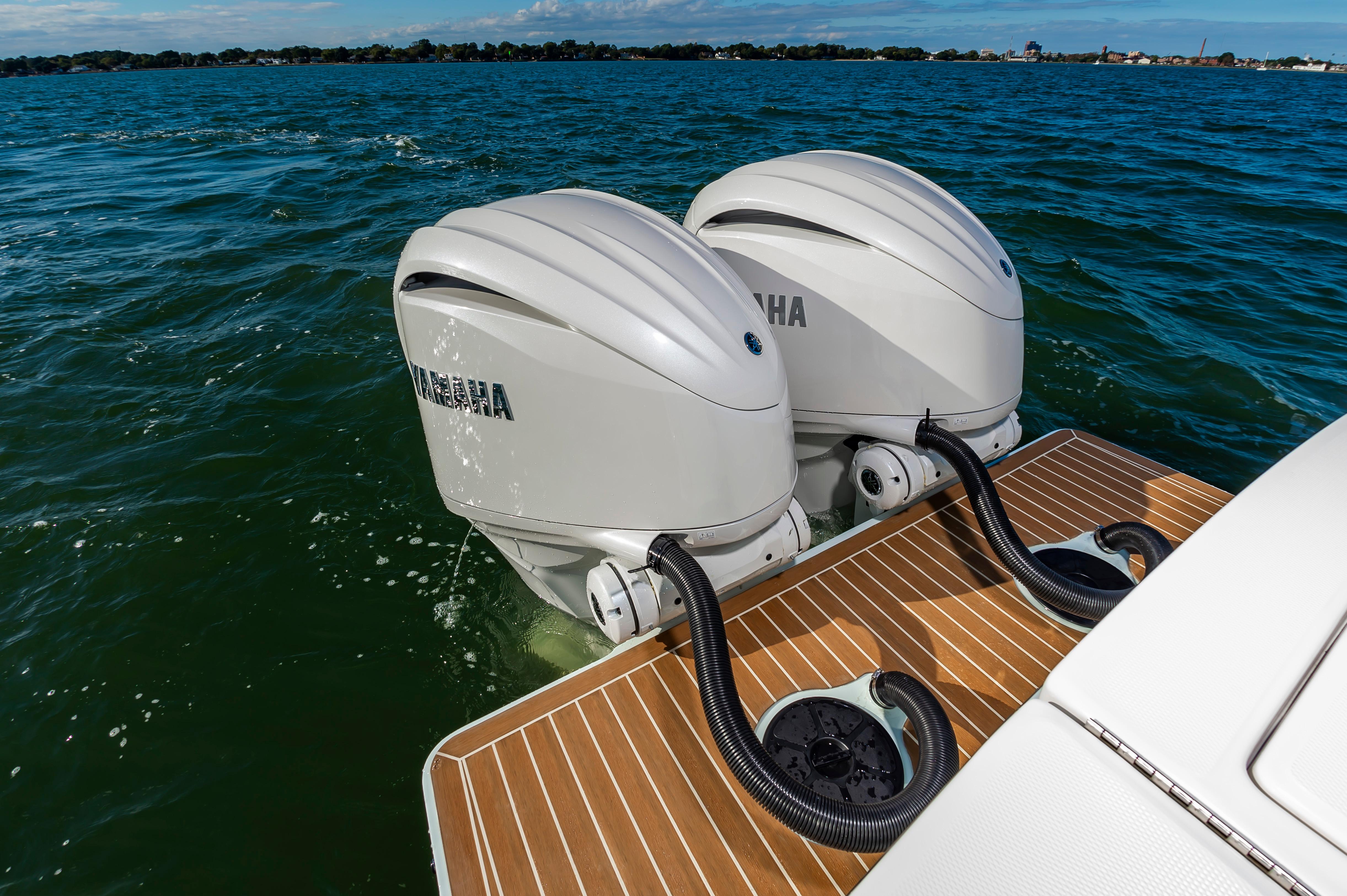 Slide: The Image of 2024 Regulator 28 boat with twin Yamaha outboard engines on the water. - 18