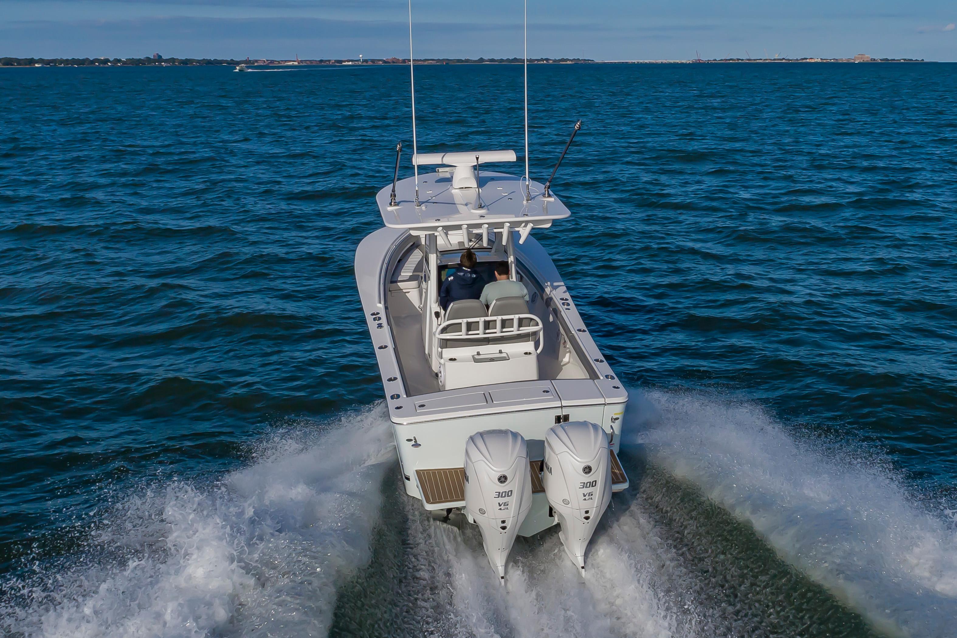 Slide: The Image of 2024 Regulator 28 boat cruising on open water with twin 300 V6 engines. - 2