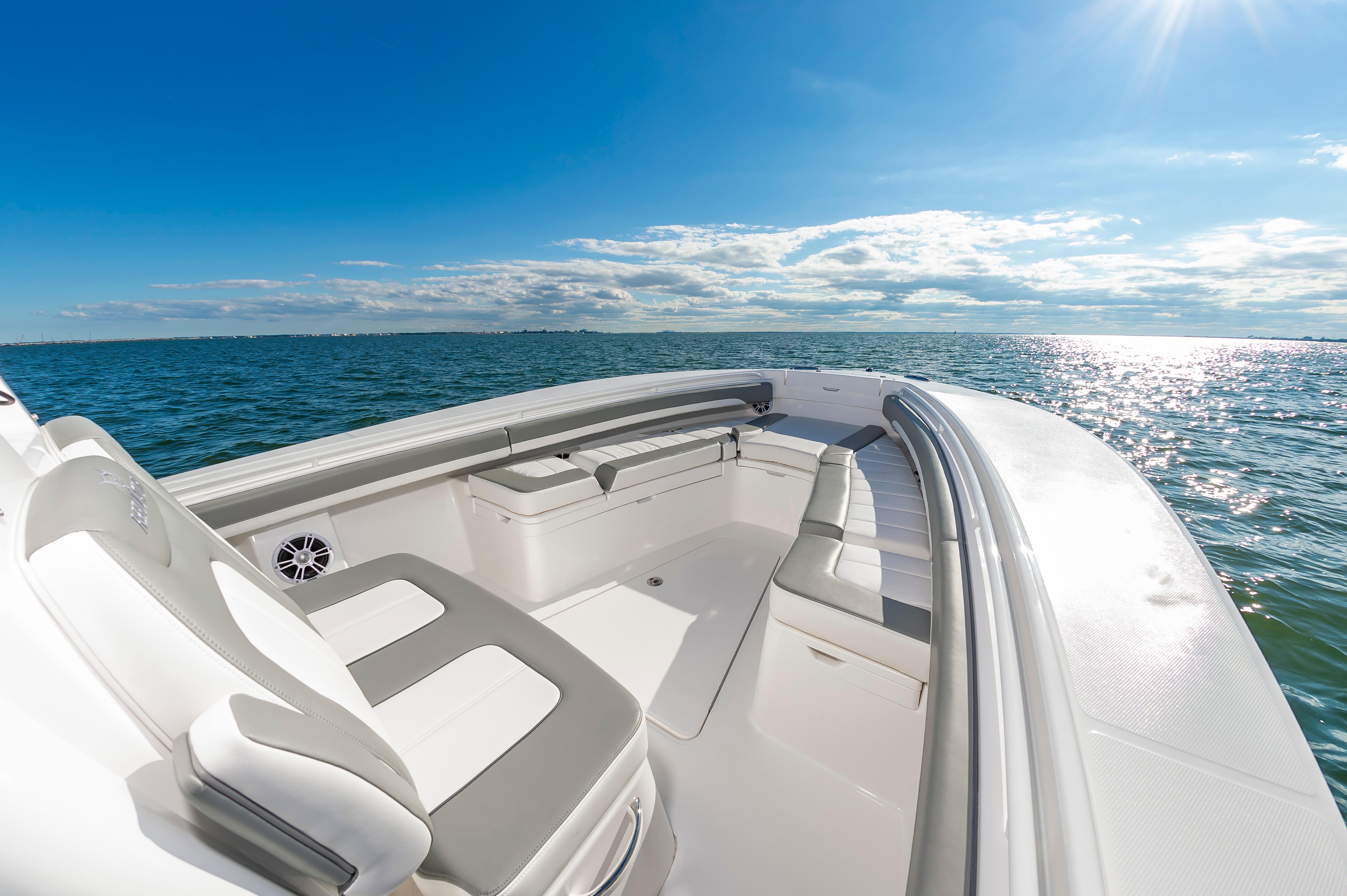 Slide: The Image of 2024 Regulator 28 boat interior with seating, on a sunny day at sea. - 21