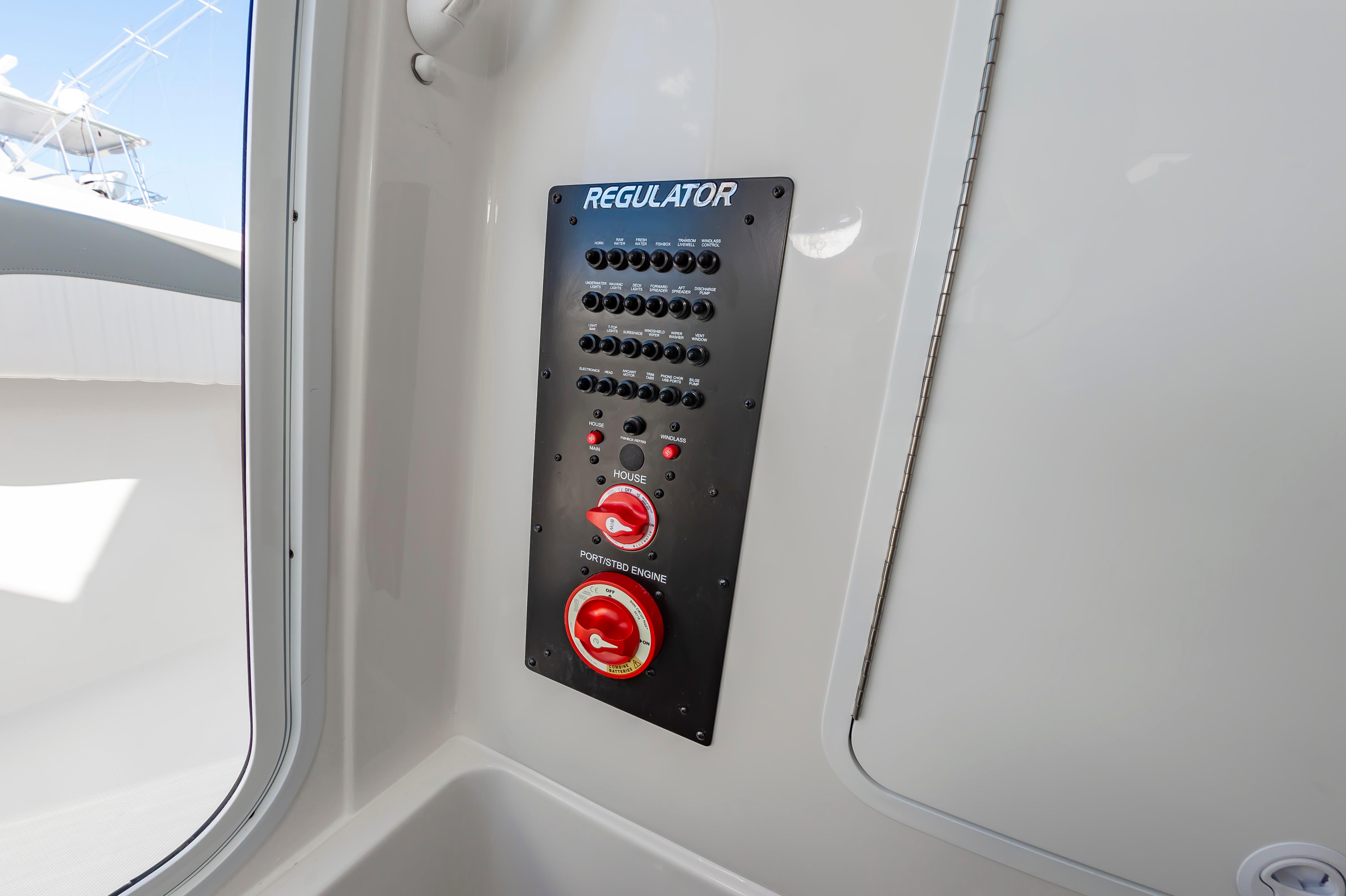 Slide: The Image of Control panel of a 2024 Regulator 28 boat with switches and dials. - 29