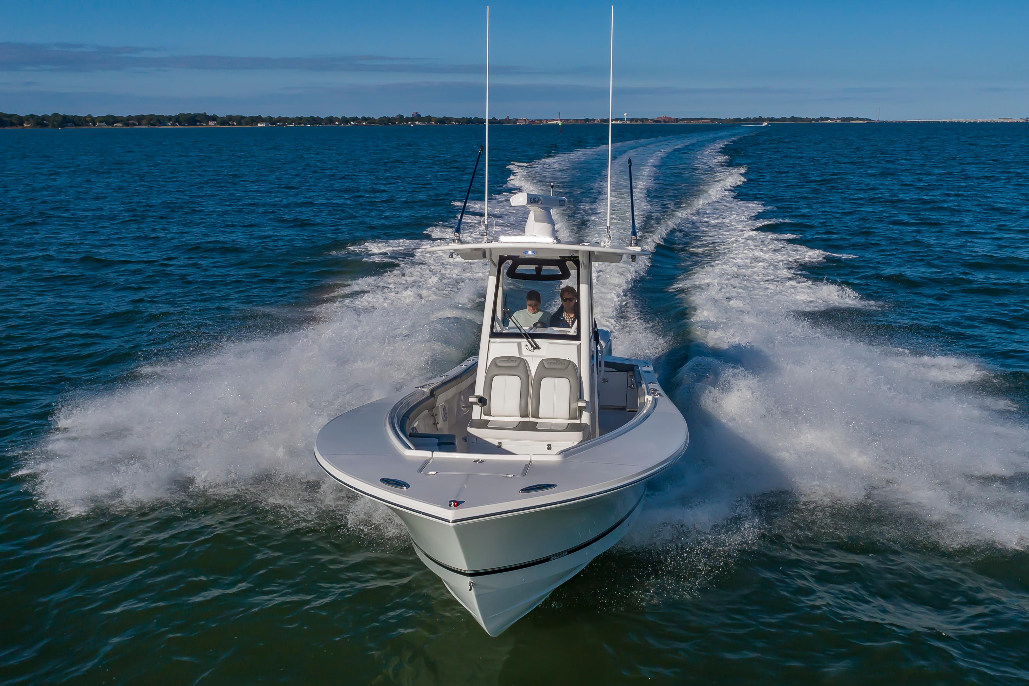 Slide: The Image of 2024 Regulator 28 boat cruising on open water. - 4