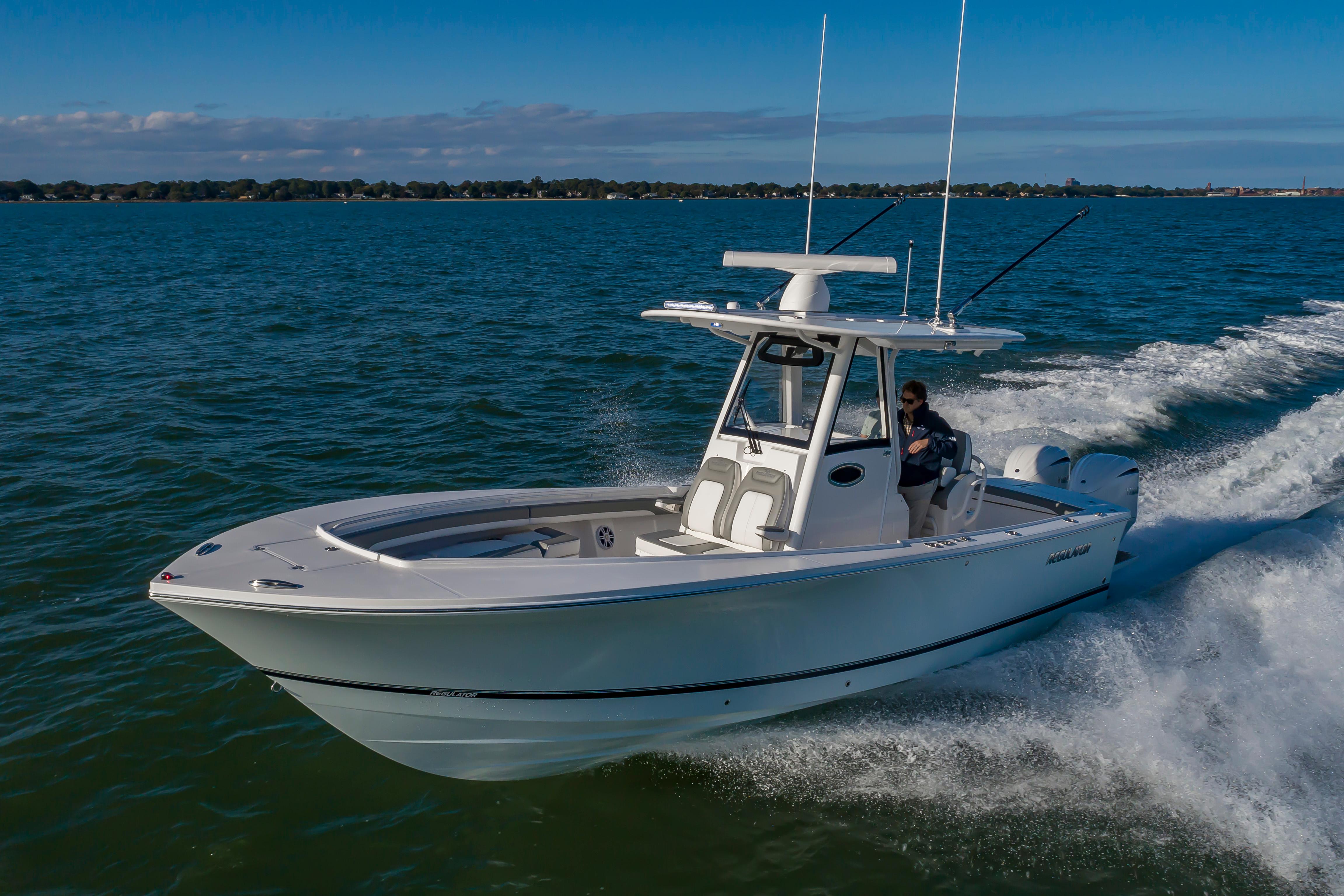 Slide: The Image of 2024 Regulator 28 boat cruising on open water. - 5