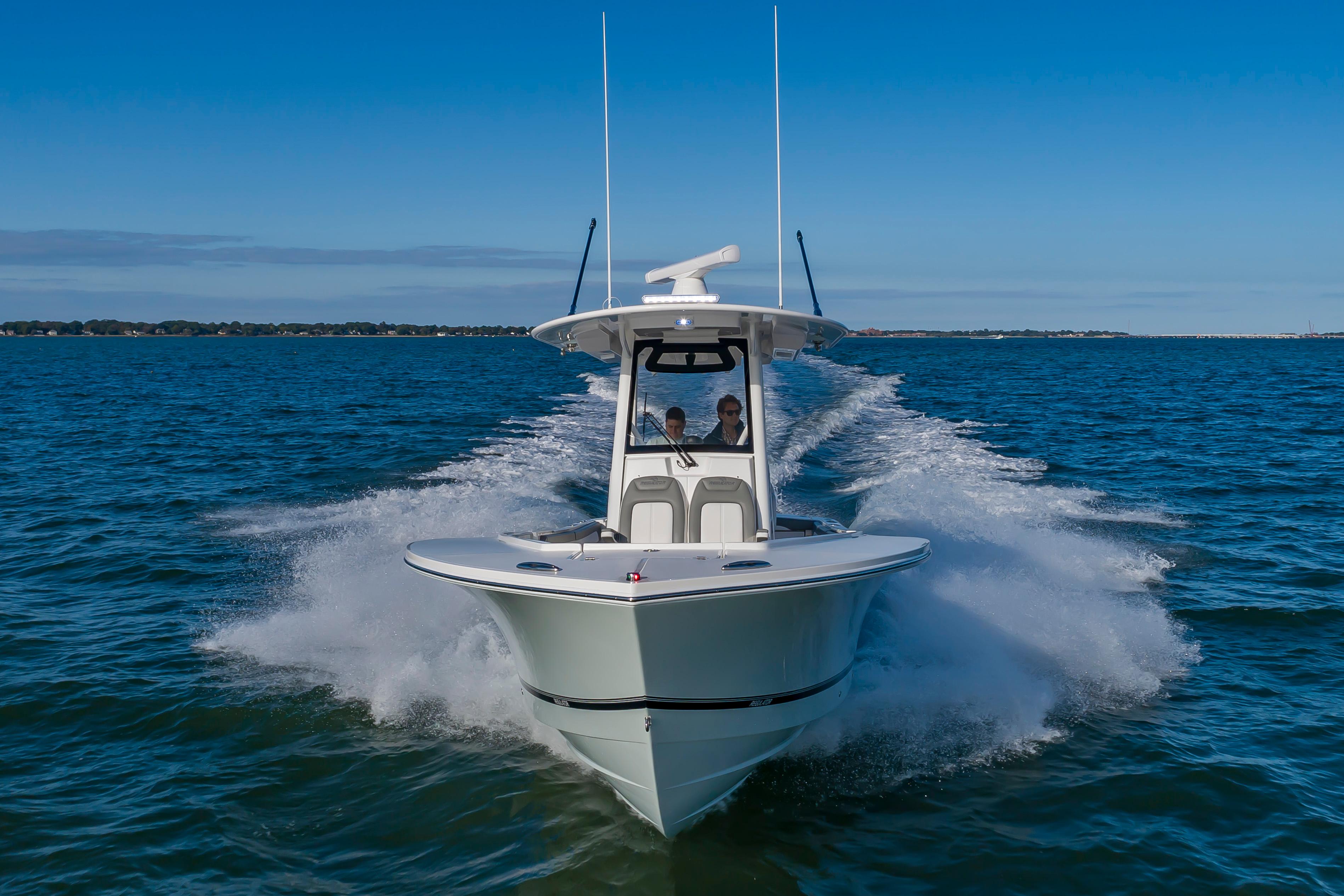 Slide: The Image of 2024 Regulator 28 boat cruising on open water. - 6