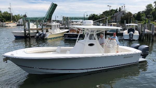 Slide: The Image of 2018 Regulator 28 Center Console boat with Optimus 360 Joystick Control in a marina. - 19