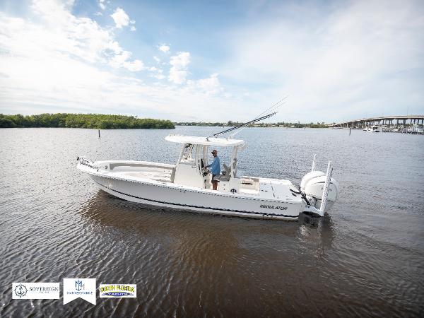 Slide: The Image of 2024 Regulator 30XO boat on calm water with clear sky. - 1