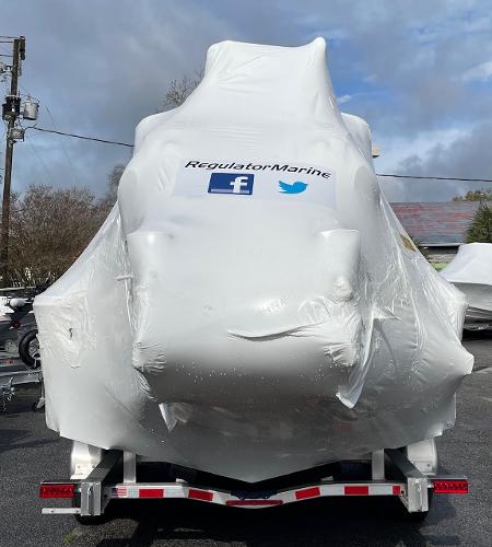 Slide: The Image of 2024 Regulator 30XO boat covered in protective wrap on a trailer. - 21