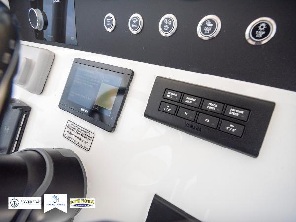 Slide: The Image of 2024 Regulator 30XO boat dashboard with Yamaha controls and digital display. - 24