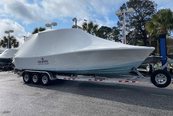 Slide: The Image of 2024 Regulator 30XO boat covered on a trailer in a parking lot. - 3