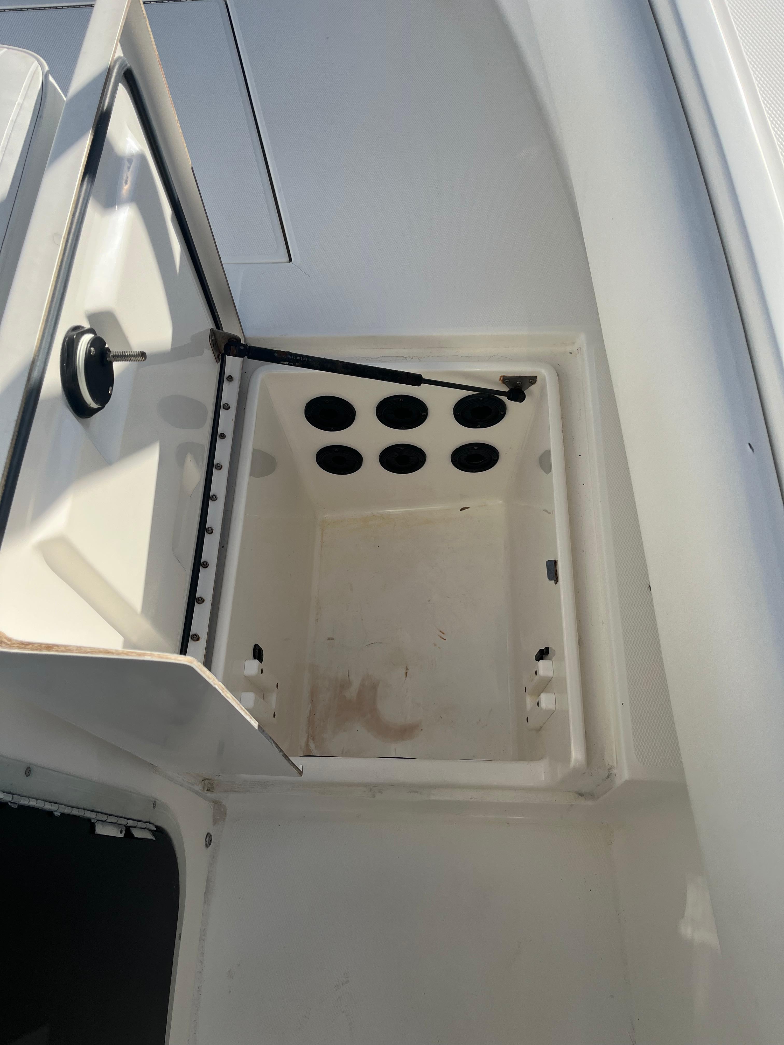 Slide: The Image of Open storage compartment on a 2000 Regulator 32 Center Console boat. - 16