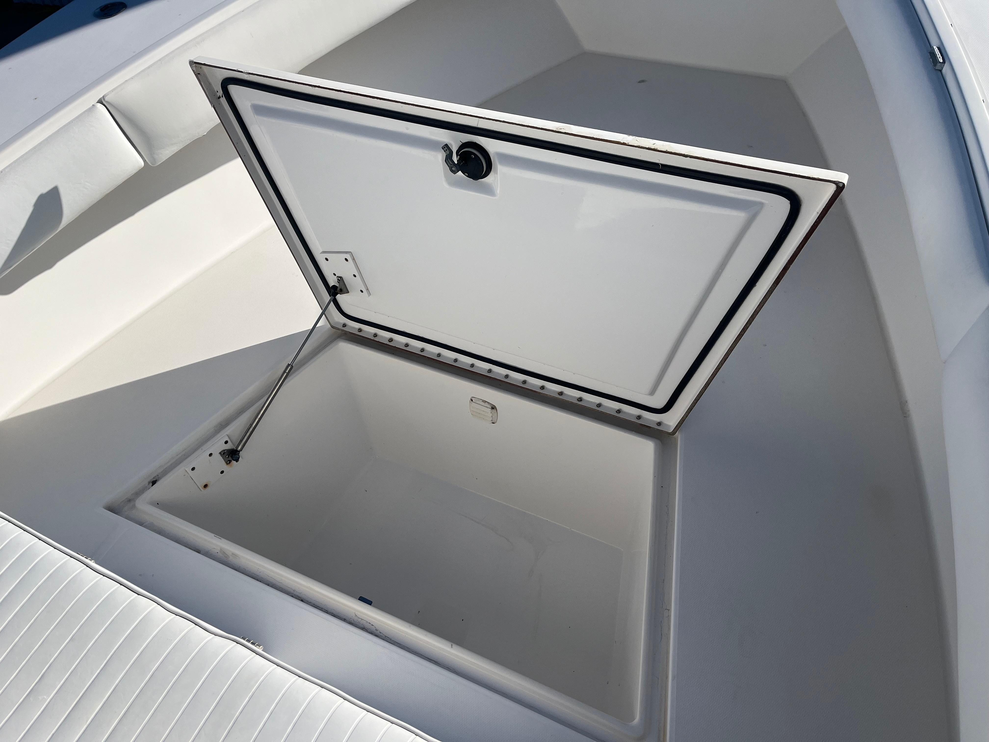 Slide: The Image of Open storage compartment on a 2000 Regulator 32 Center Console boat. - 18
