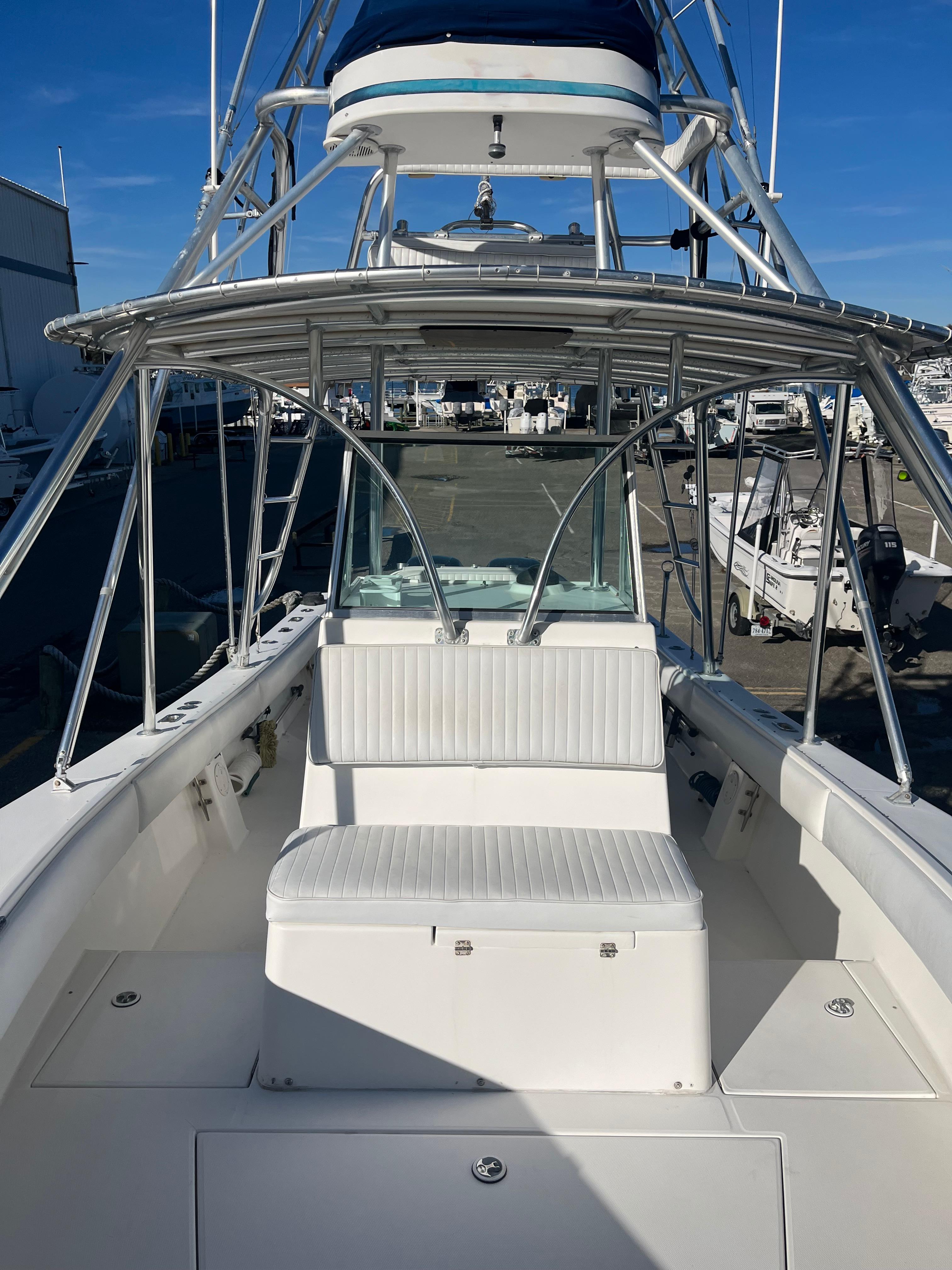 Slide: The Image of 2000 Regulator 32 Center Console boat with seating and tower, docked at marina. - 19