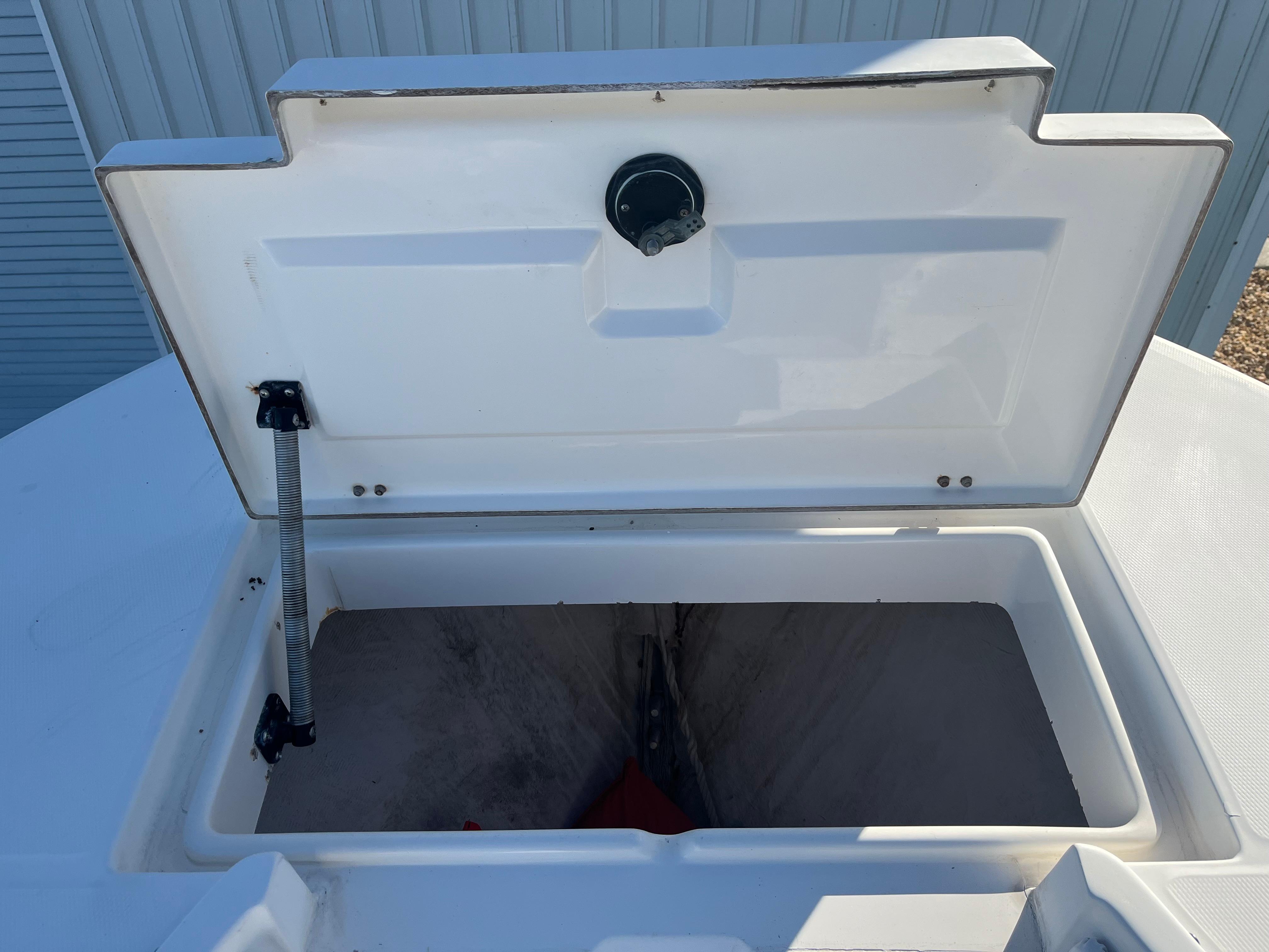 Slide: The Image of Open storage compartment on a 2000 Regulator 32 Center Console boat. - 20