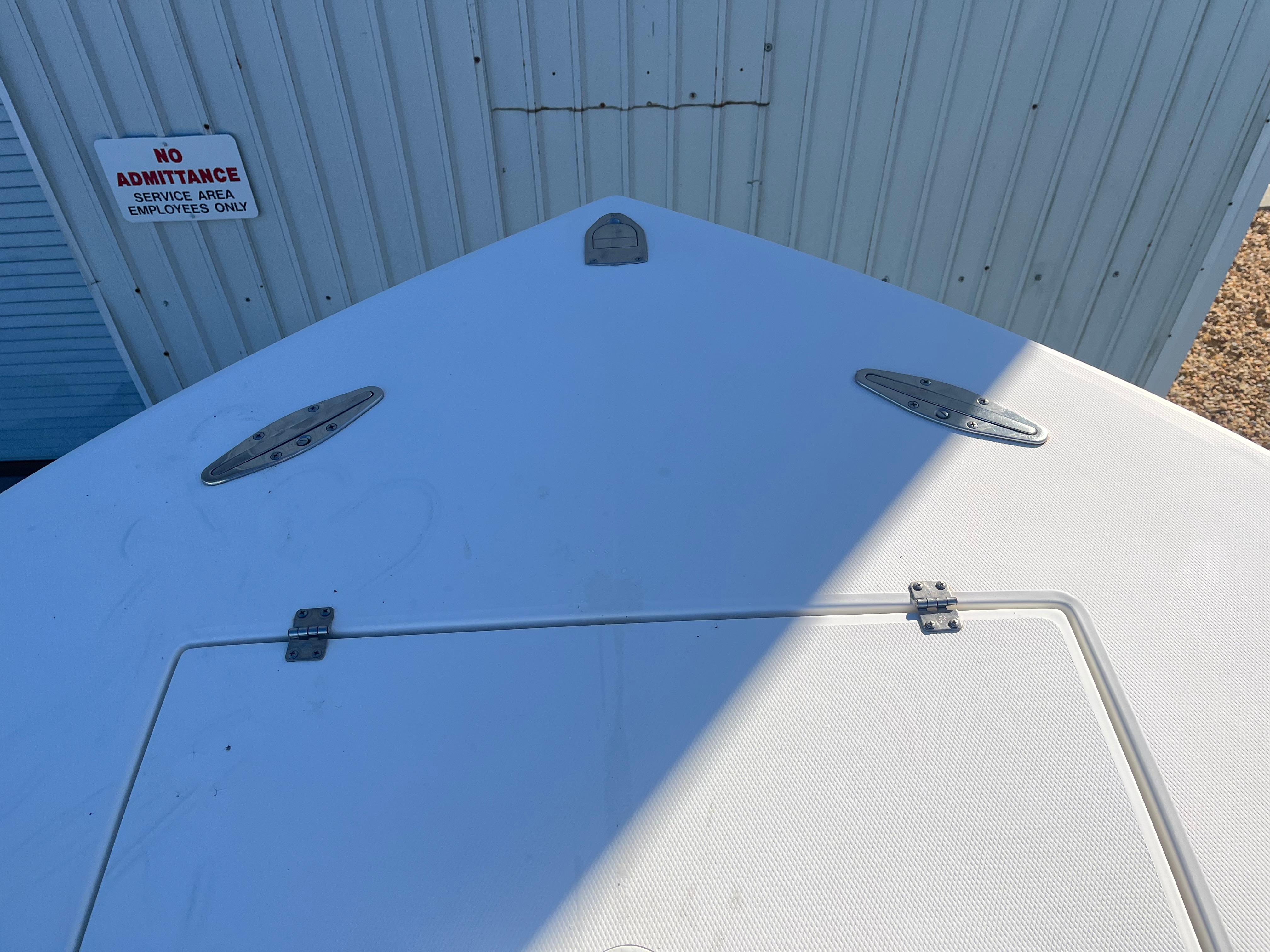 Slide: The Image of Bow of 2000 Regulator 32 Center Console boat near service area sign. - 21