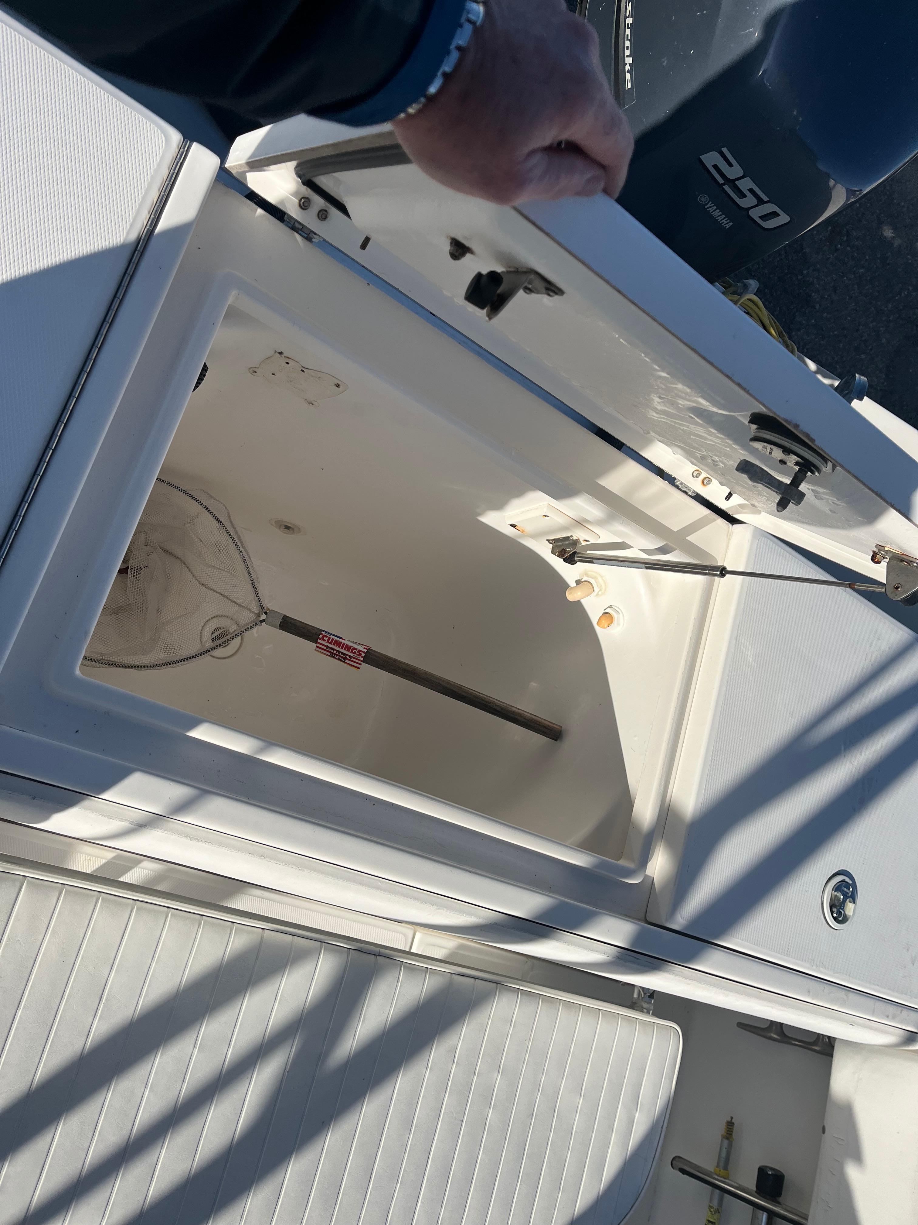 Slide: The Image of Open storage compartment on a 2000 Regulator 32 Center Console boat. - 23