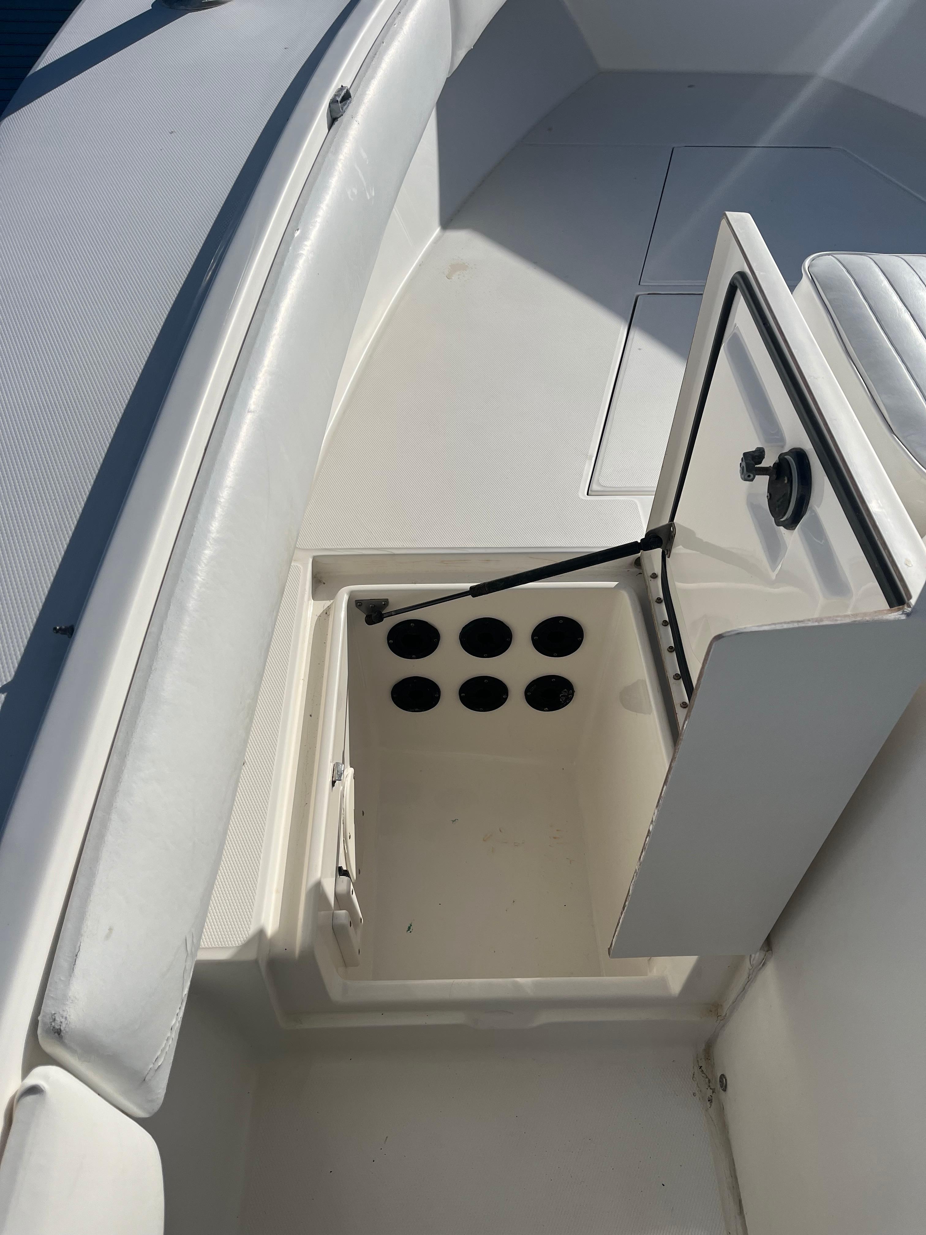 Slide: The Image of Open storage compartment on a 2000 Regulator 32 Center Console boat. - 27