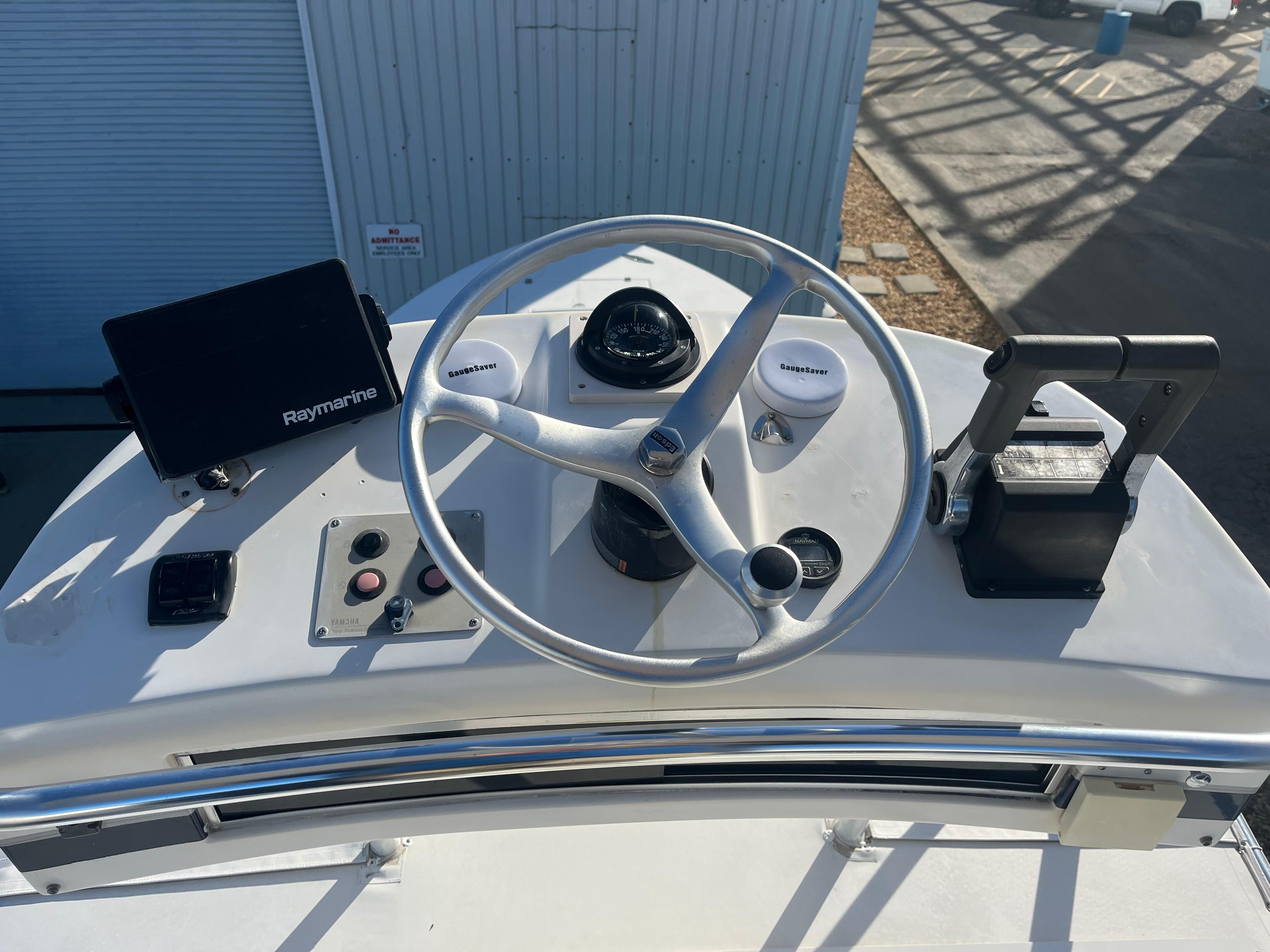 Slide: The Image of Center console of 2000 Regulator 32 boat with steering wheel and Raymarine display. - 29