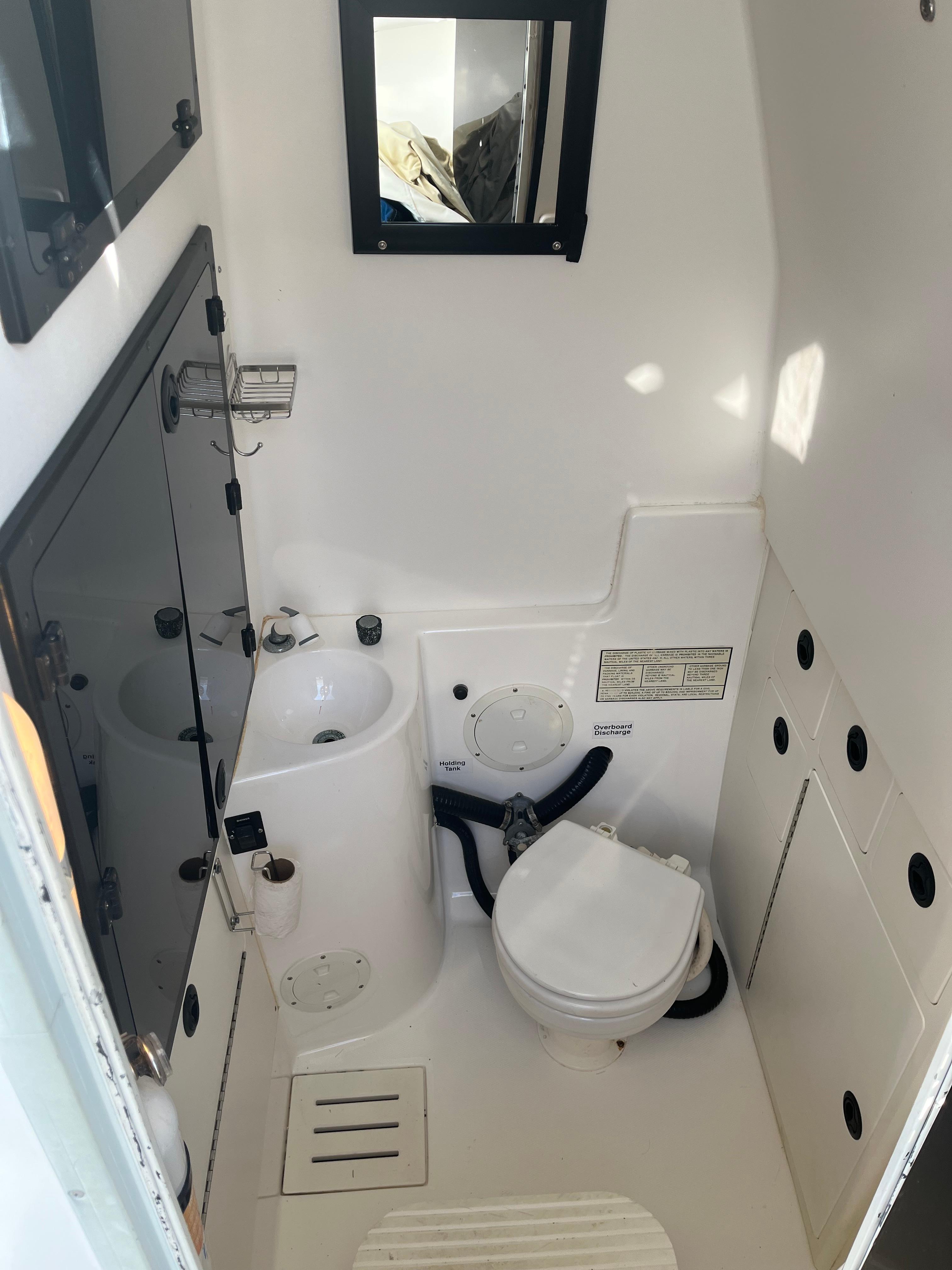 Slide: The Image of Compact marine bathroom in a 2000 Regulator 32 Center Console boat. - 31