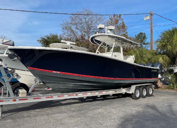 Slide: The Image of 2016 Regulator 34SS boat on trailer, sleek design, dark hull, outdoor setting. - 11