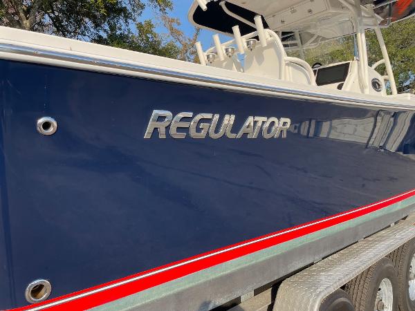 Slide: The Image of 2016 Regulator 34SS boat with blue hull and red stripe on trailer. - 15
