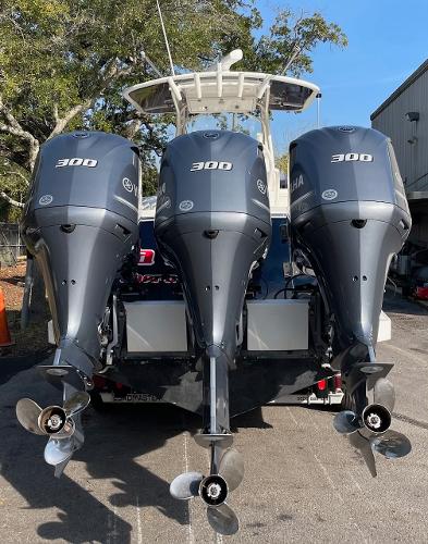 Slide: The Image of 2016 Regulator 34SS boat with triple Yamaha 300 engines, parked outdoors. - 18