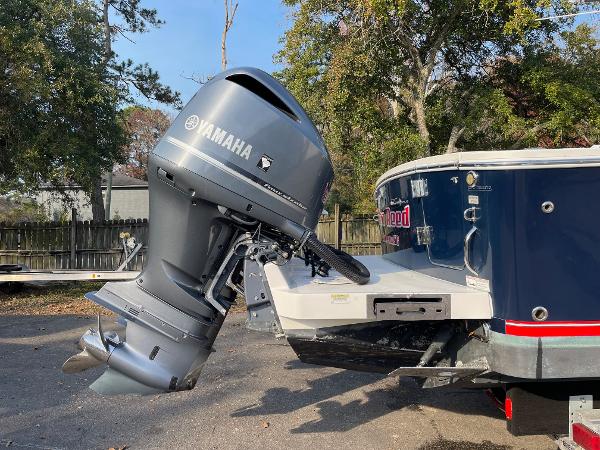 Slide: The Image of 2016 Regulator 34SS boat with Yamaha outboard motor, parked outdoors. - 19