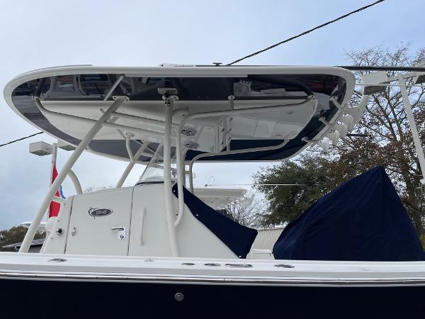 Slide: The Image of 2016 Regulator 34SS boat with T-top and covered seating, viewed from the side. - 21