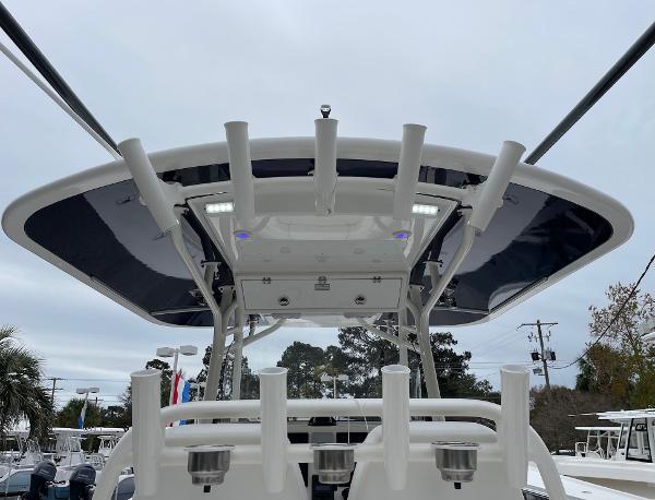Slide: The Image of 2016 Regulator 34SS boat with T-top and rod holders, viewed from the rear. - 22