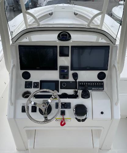 Slide: The Image of 2016 Regulator 34SS boat dashboard with dual screens and navigation controls. - 23