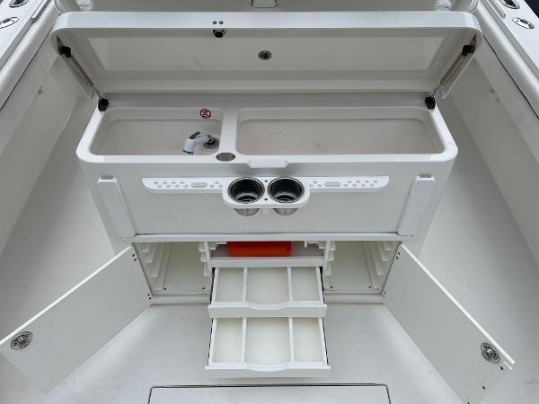Slide: The Image of 2016 Regulator 34SS boat storage compartment with open drawers and doors. - 31