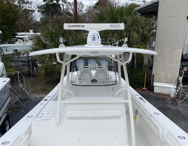 Slide: The Image of 2016 Regulator 34SS boat with Garmin radar, white exterior, docked near palm trees. - 36