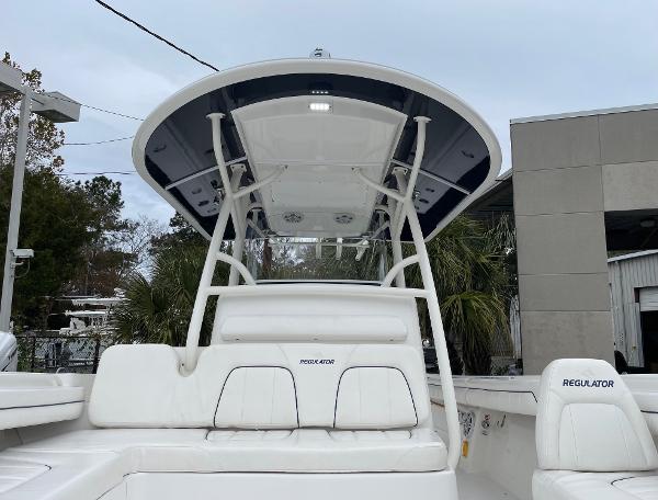 Slide: The Image of 2016 Regulator 34SS boat with white seating and T-top, docked outdoors. - 37