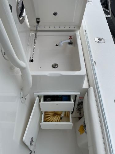 Slide: The Image of 2016 Regulator 34SS boat storage compartments and sink detail. - 38