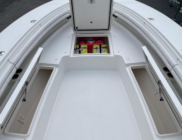 Slide: The Image of 2016 Regulator 34SS boat storage compartments with open hatches and visible safety equipment. - 47