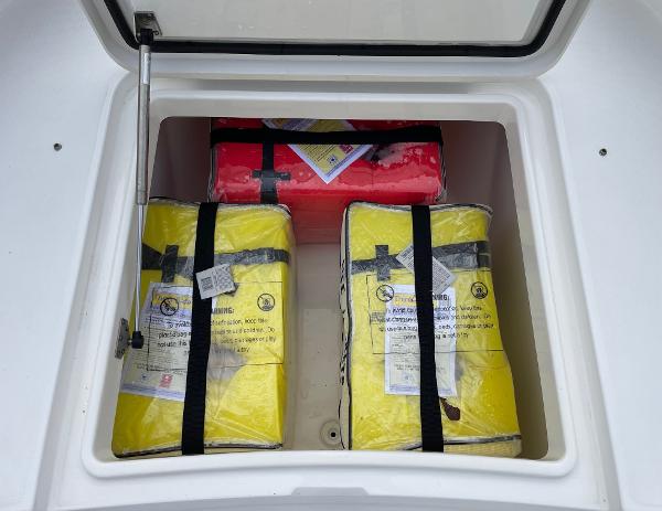 Slide: The Image of Storage compartment on a 2016 Regulator 34SS boat with safety equipment. - 48